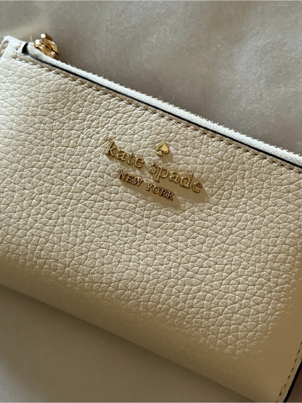 kate spade cream pebble leather wallet with pink interior/gold details